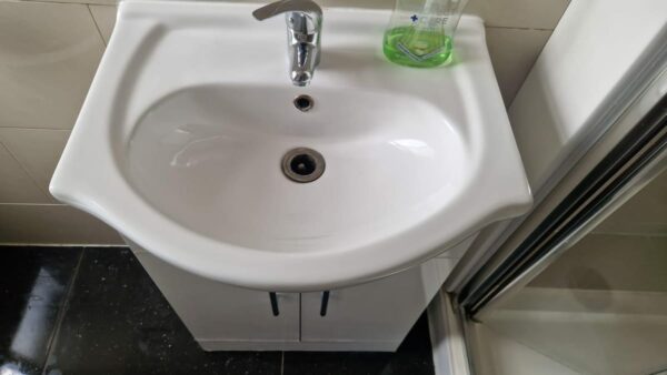 Bathroom basin on a white vanity unit
