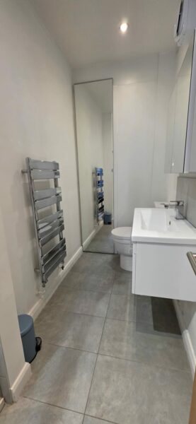 Bathroom with a heated towel rail and a basin