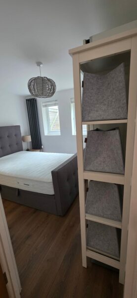 Bedroom with a double bed and open shelving