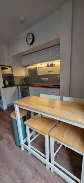 Kitchen with a wooden breakfast table and stools