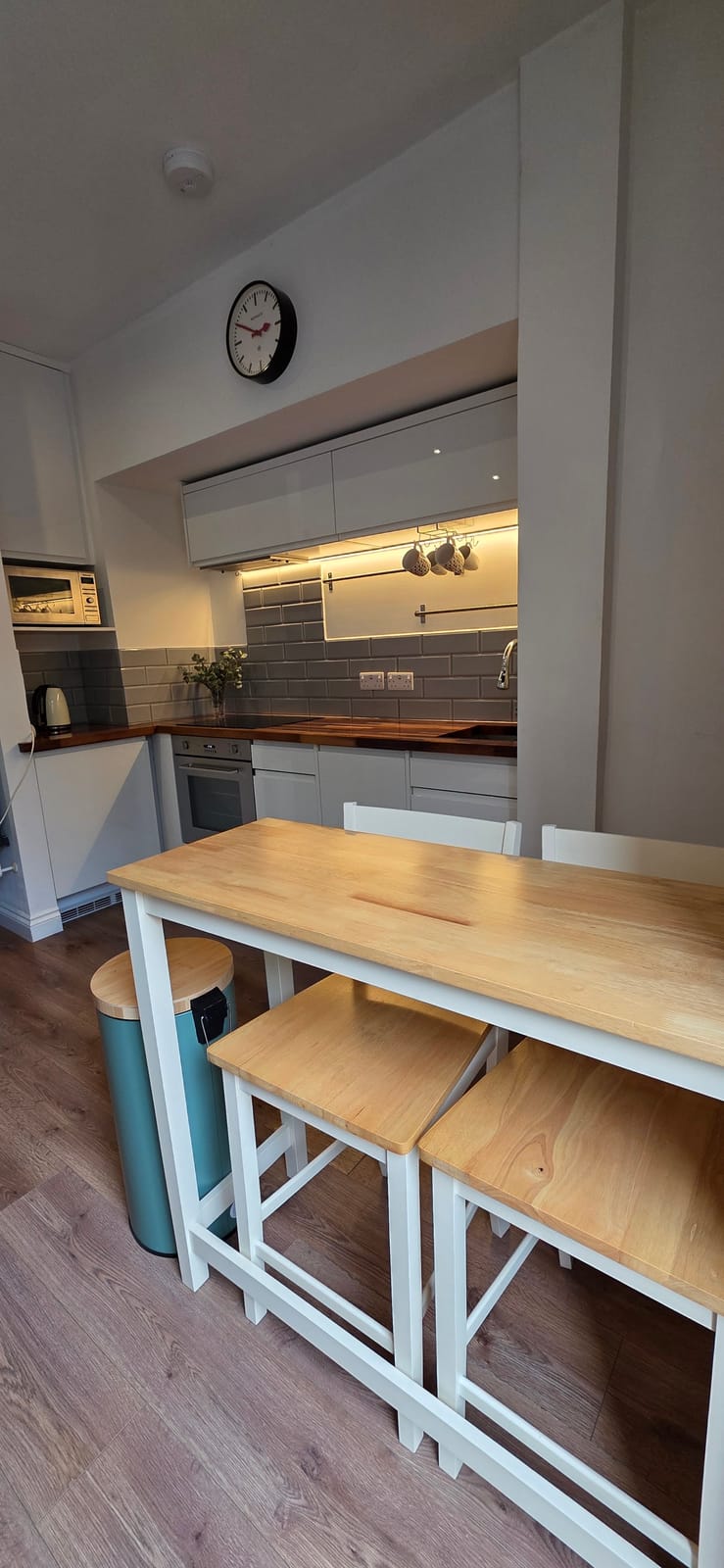 Kitchen with a wooden breakfast table and stools