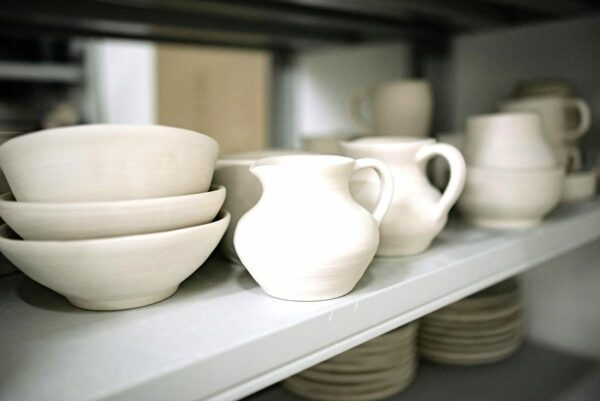 Kitchen shelf of white bowls and jugs